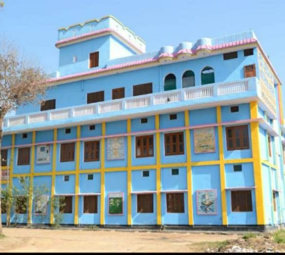 Modern school building with spacious classrooms and green playground at De'Saint Public School campus