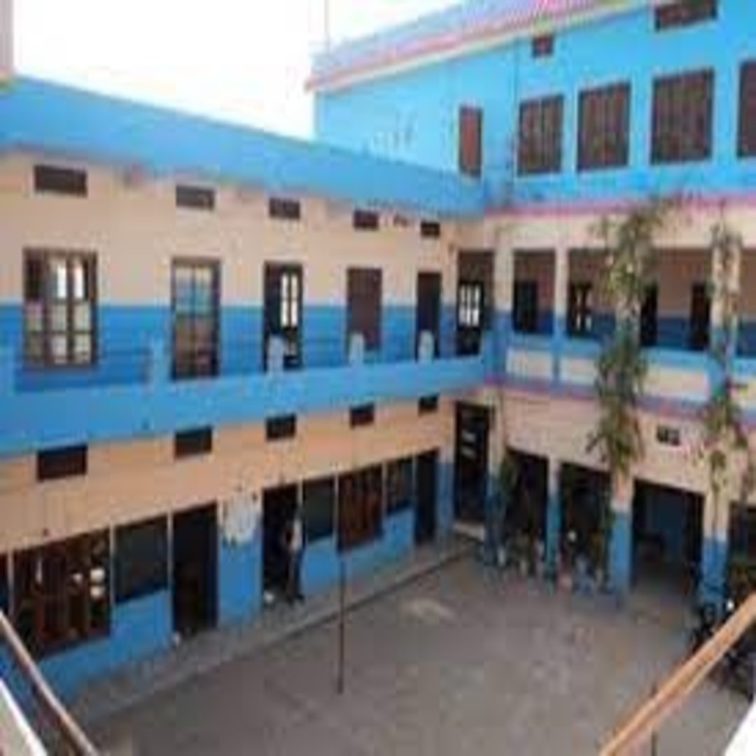 Modern school building with spacious classrooms and green playground at De'Saint Public School campus